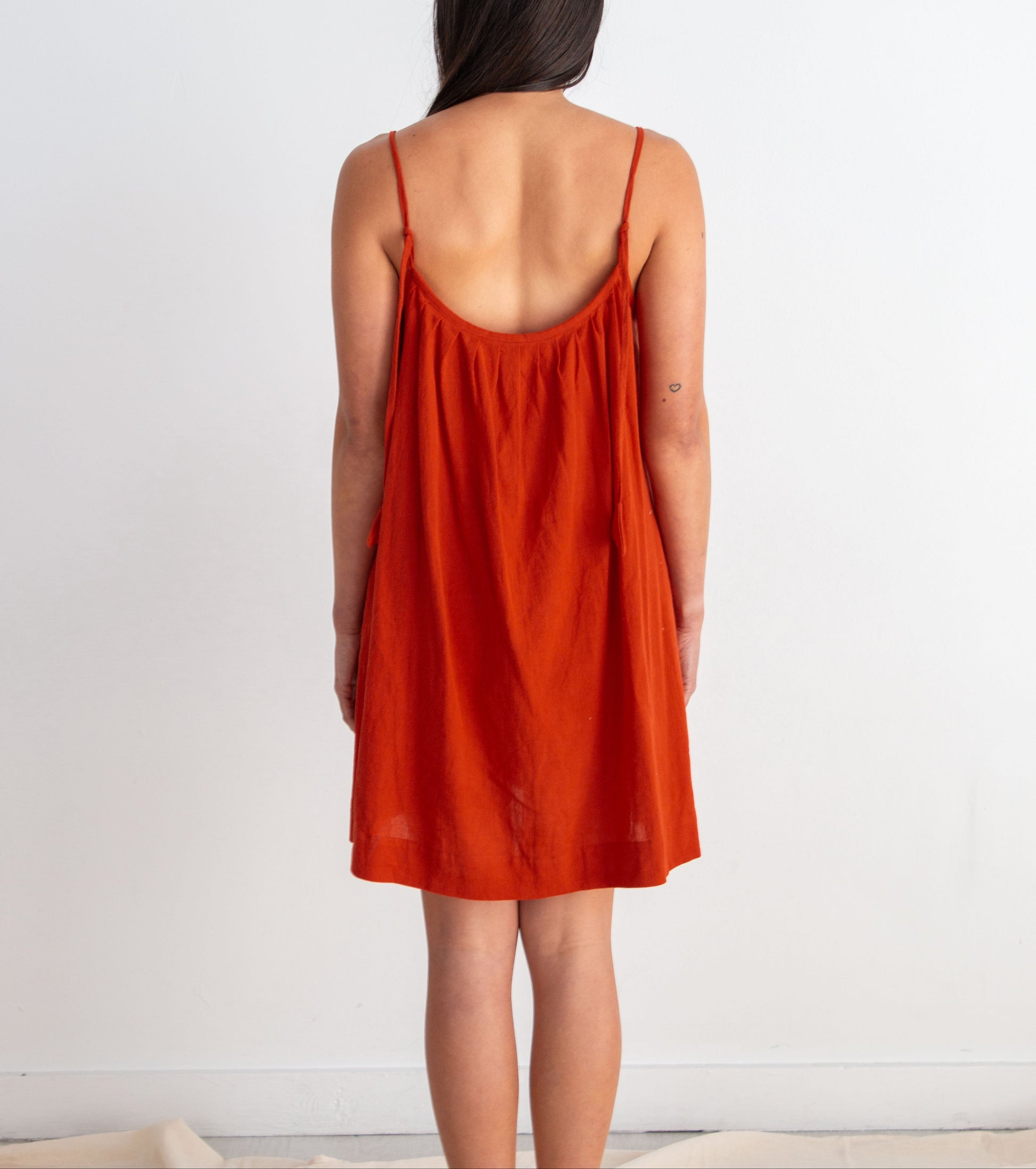 Woman wearing a red dress against a white background